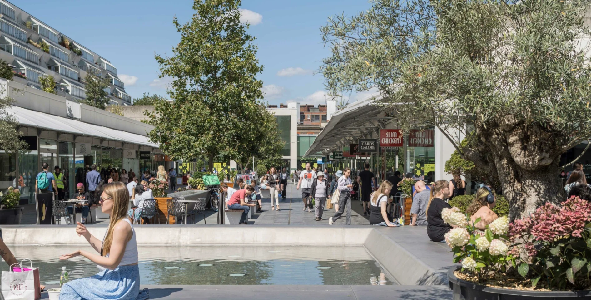 Brunswick Centre precinct with shoppers, trees and a water feature